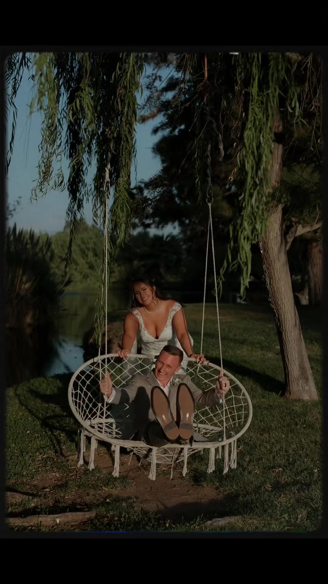 A couple on the willow swing by the pond at Hawk Ranch