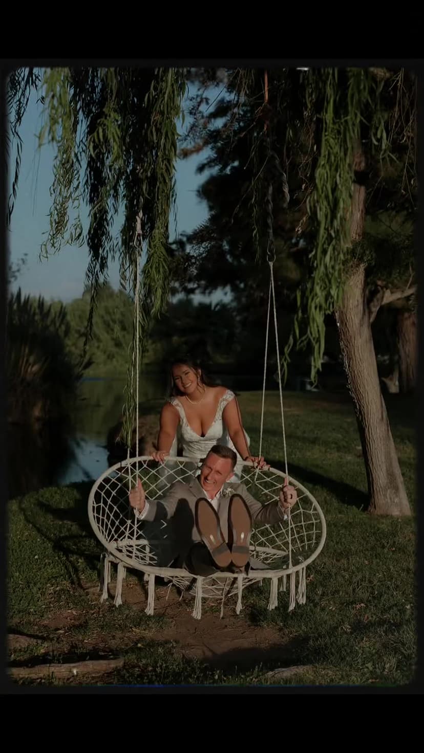 A couple on the willow swing by the pond at Hawk Ranch